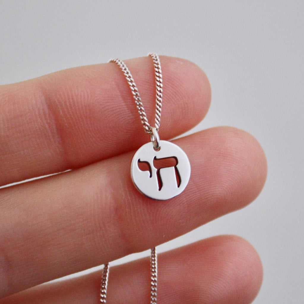 A small disk pendant with a Chai symbol by Jade Rabbit Design